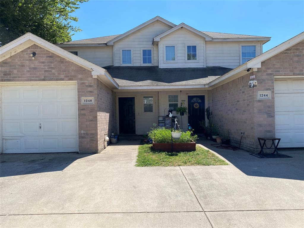 1248 Village Garden Azle, TX 76020 - Photo 1 of 9 a front view of a house with a yard