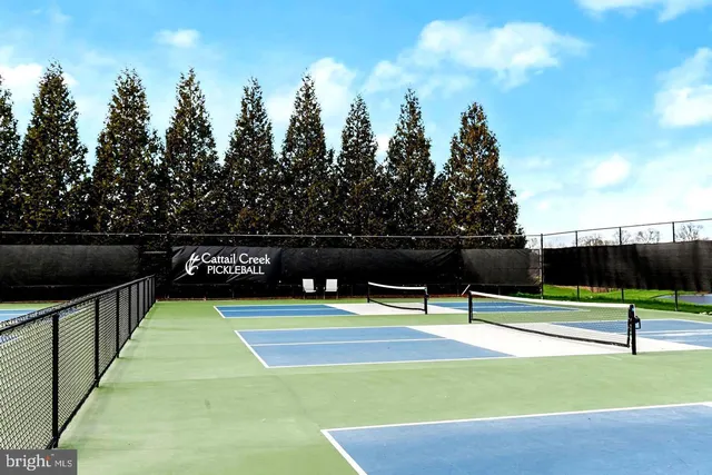 a view of a patio with lawn chairs couches and swimming pool