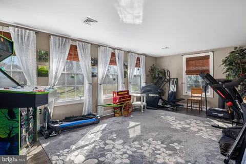 a living room with furniture a flat screen tv and a large window