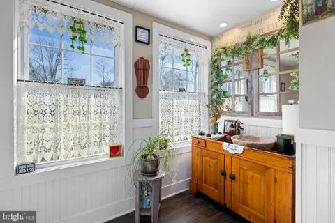 a white toilet sitting next to a bathroom next to a window