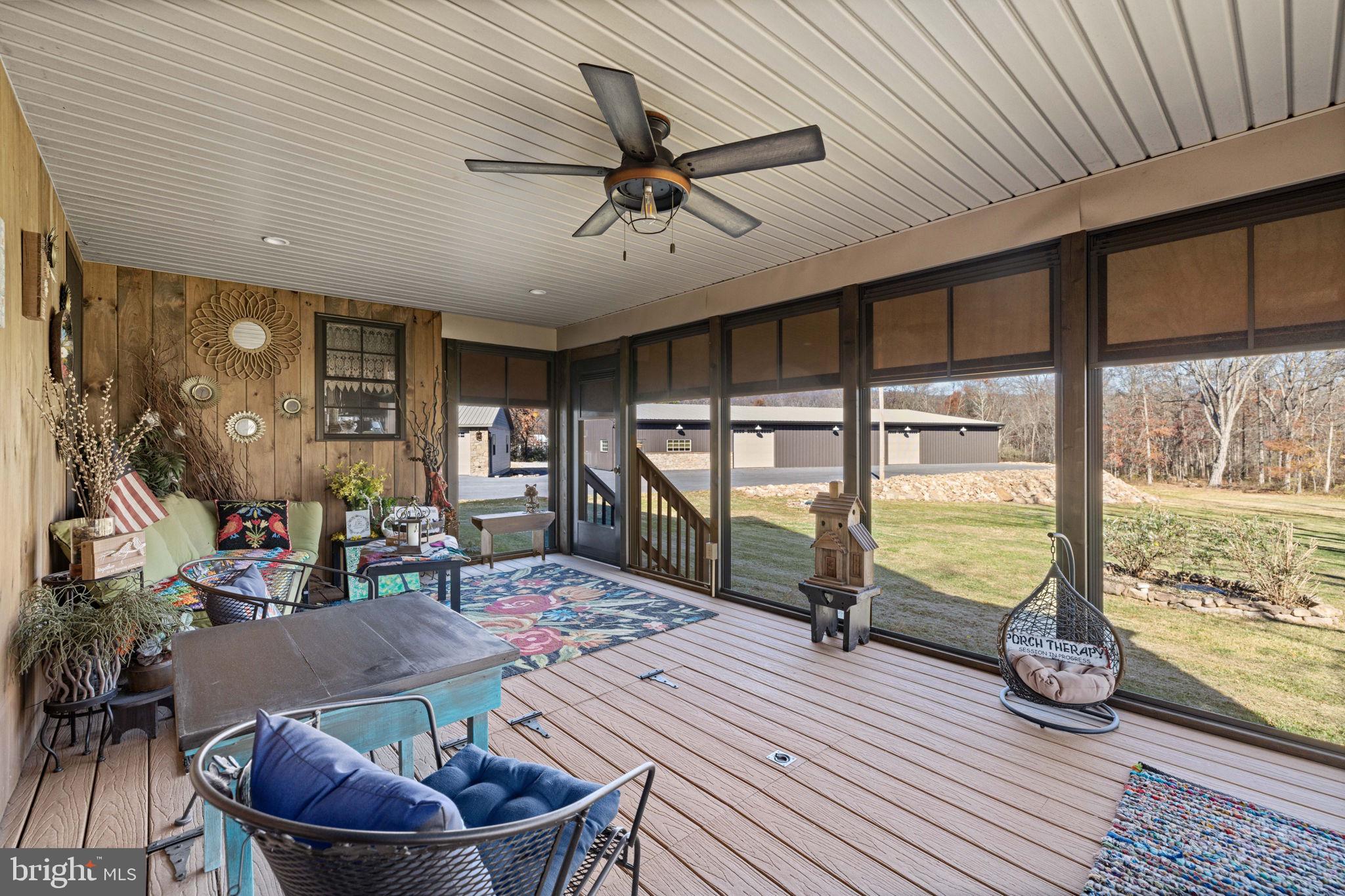 3204 Highway 72 Jonestown, PA 17038 - Photo 21 of 64 a living room with couch a dining table and a large window with wooden floor