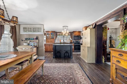 a kitchen with granite countertop a sink stainless steel appliances a refrigerator and a counter space