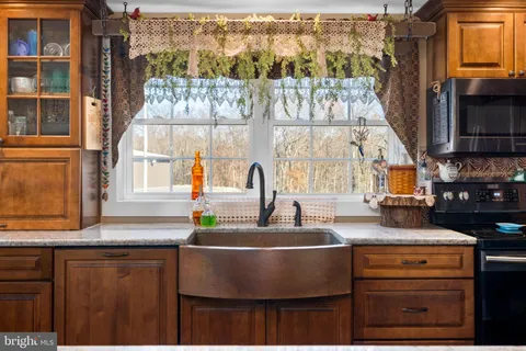 a kitchen with a stove and a wooden cabinets