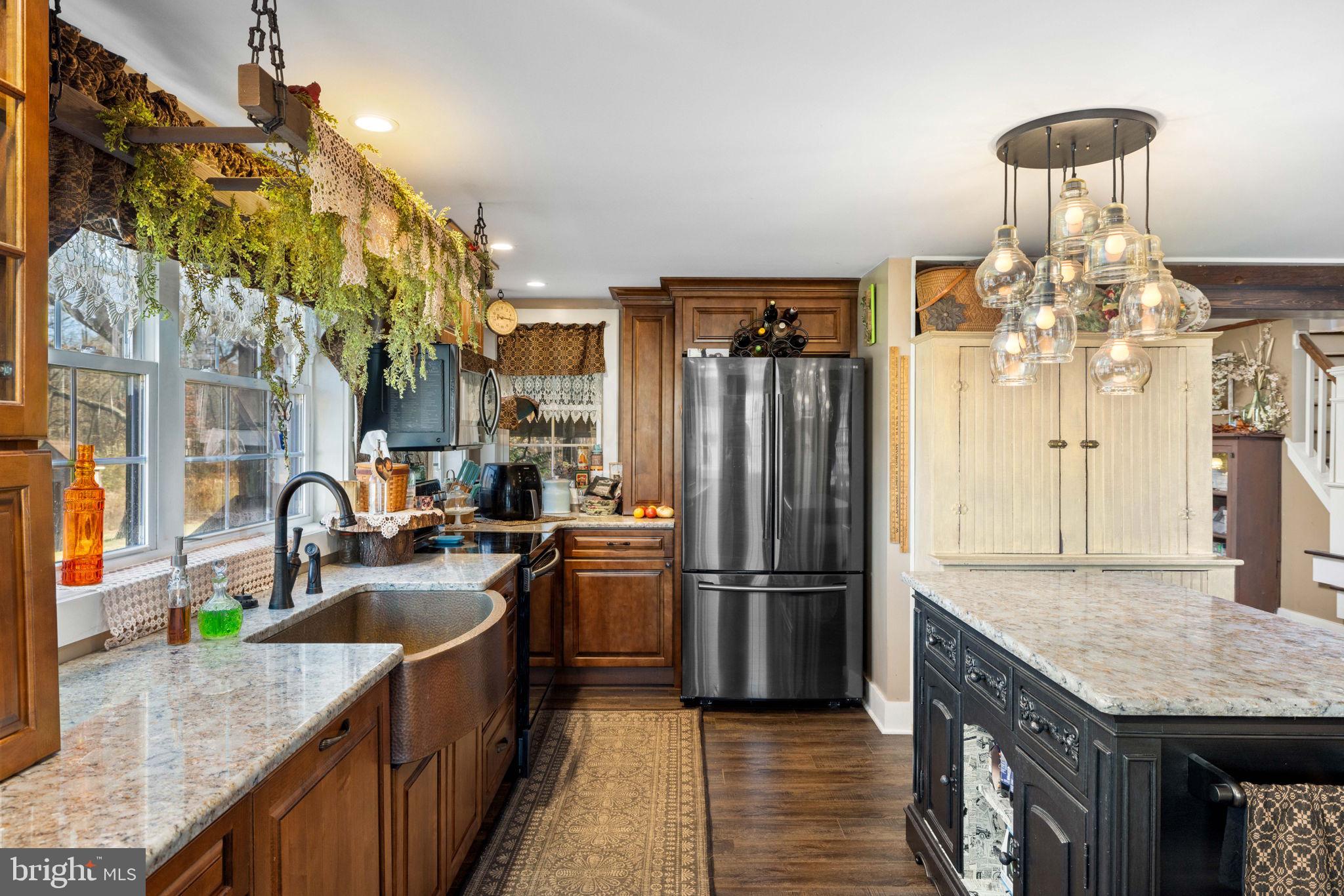 3204 Highway 72 Jonestown, PA 17038 - Photo 27 of 64 a kitchen with granite countertop a sink stainless steel appliances a refrigerator and a counter space