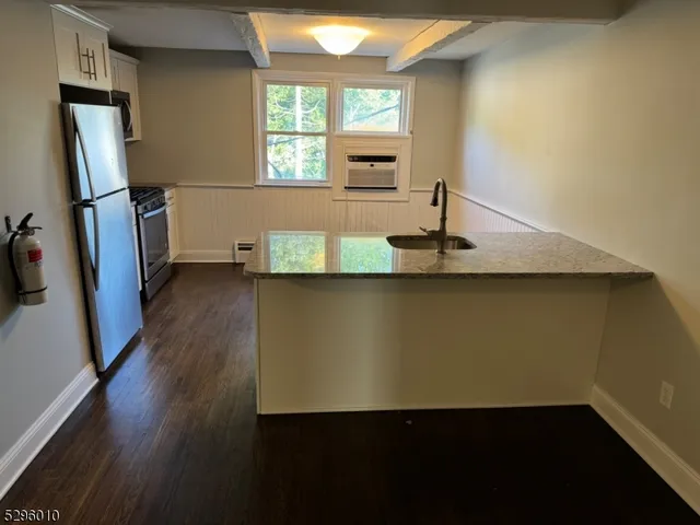a utility room with wooden floor washer and dryer