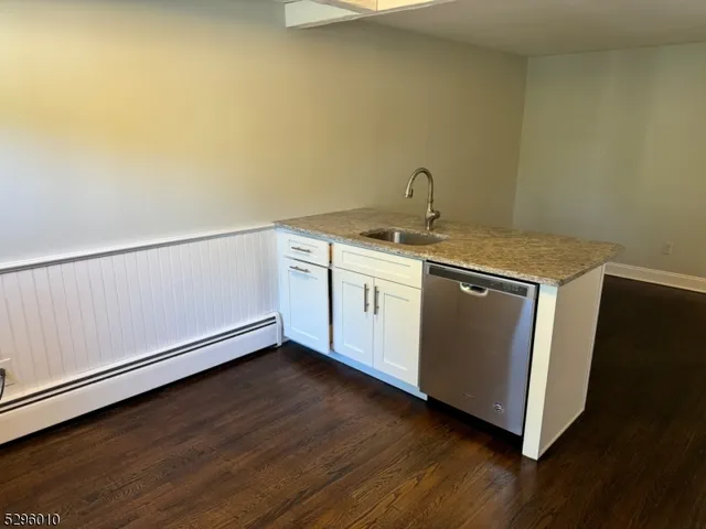a kitchen with a refrigerator and a stove top oven