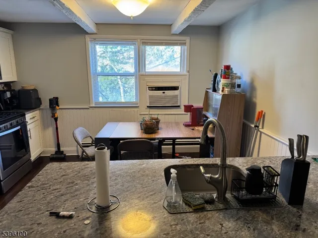 a kitchen with a refrigerator and a stove top oven