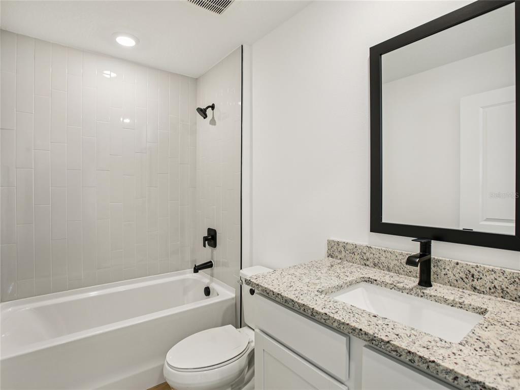 Undisclosed Address Lakeland, FL 33809 - Photo 6 of 7 a bathroom with a granite countertop sink toilet and shower