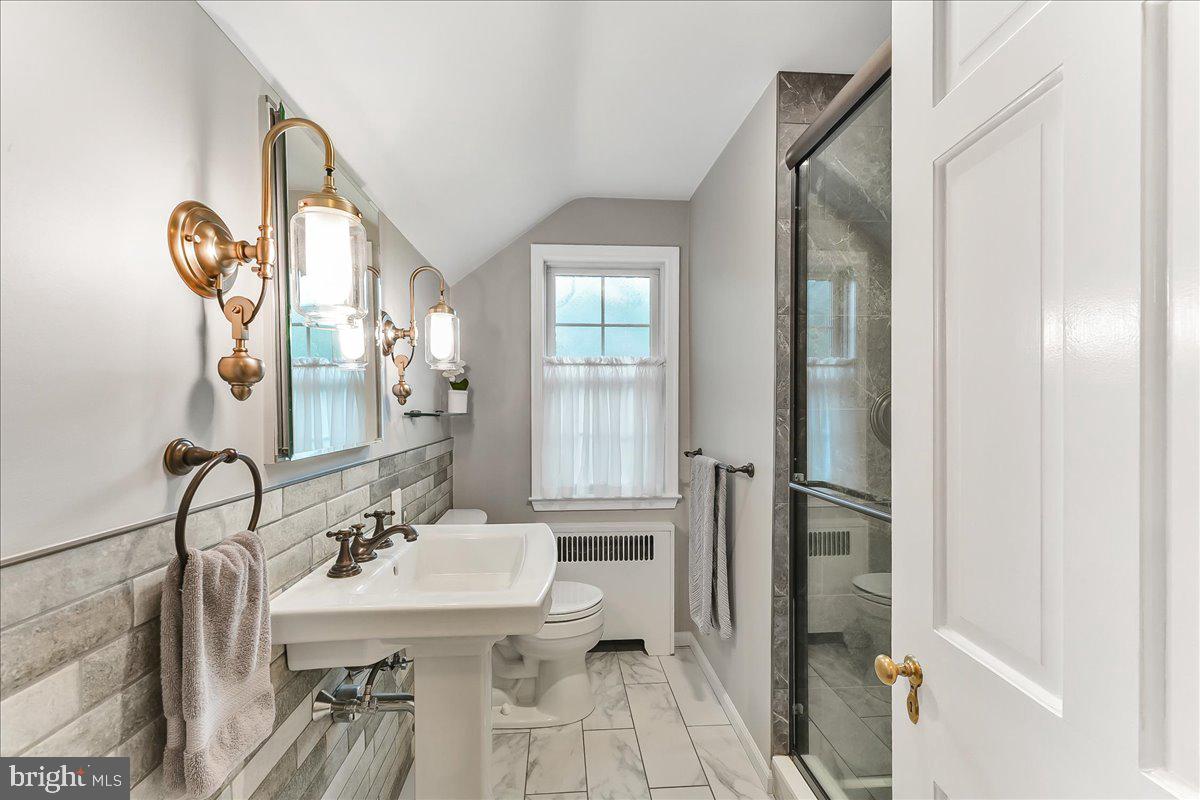 106 Barley Mill Road Wallingford, PA 19086 - Photo 21 of 50 a bathroom with a sink a toilet and a mirror