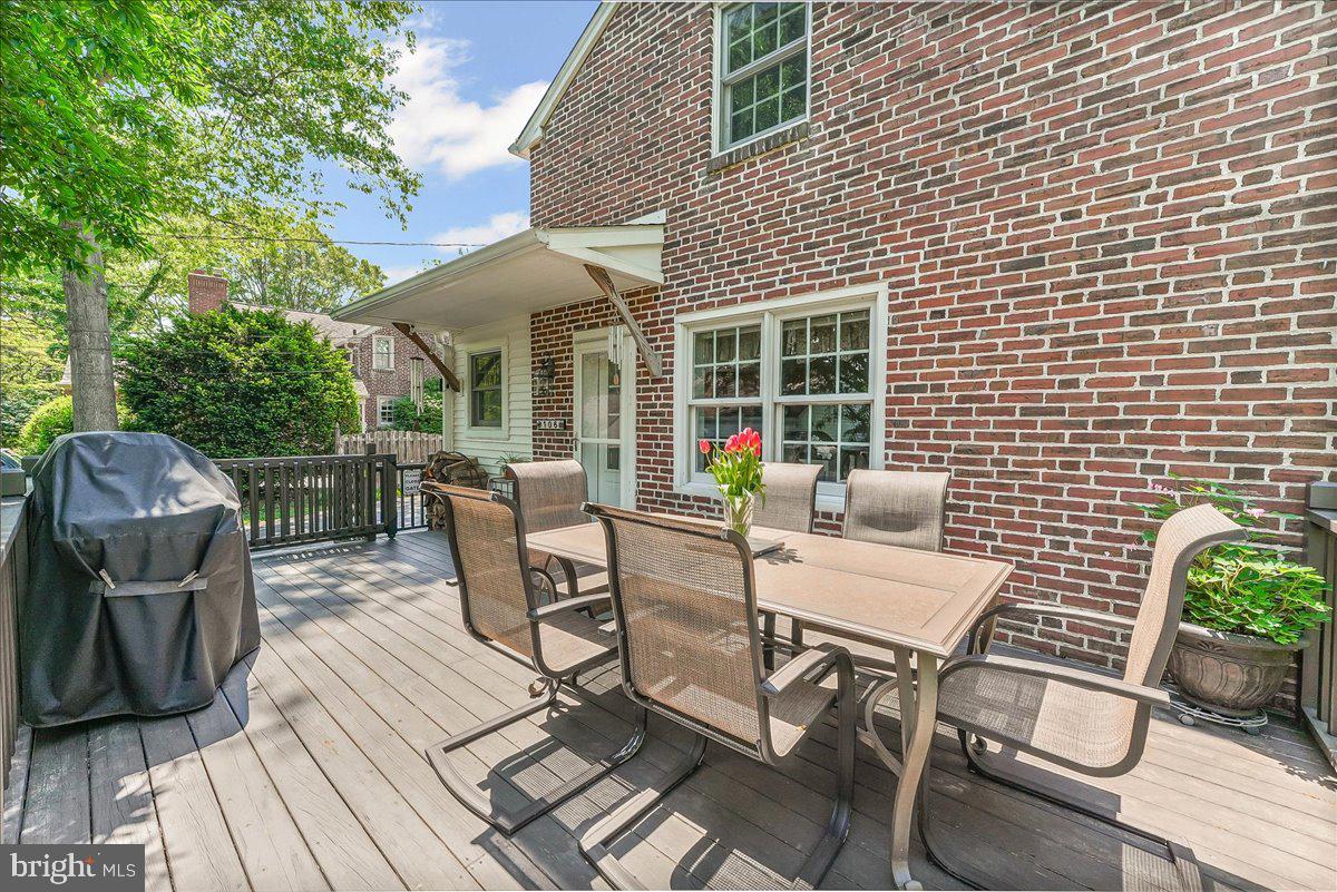 106 Barley Mill Road Wallingford, PA 19086 - Photo 4 of 50 a view of a patio with table and chairs with wooden floor and fence