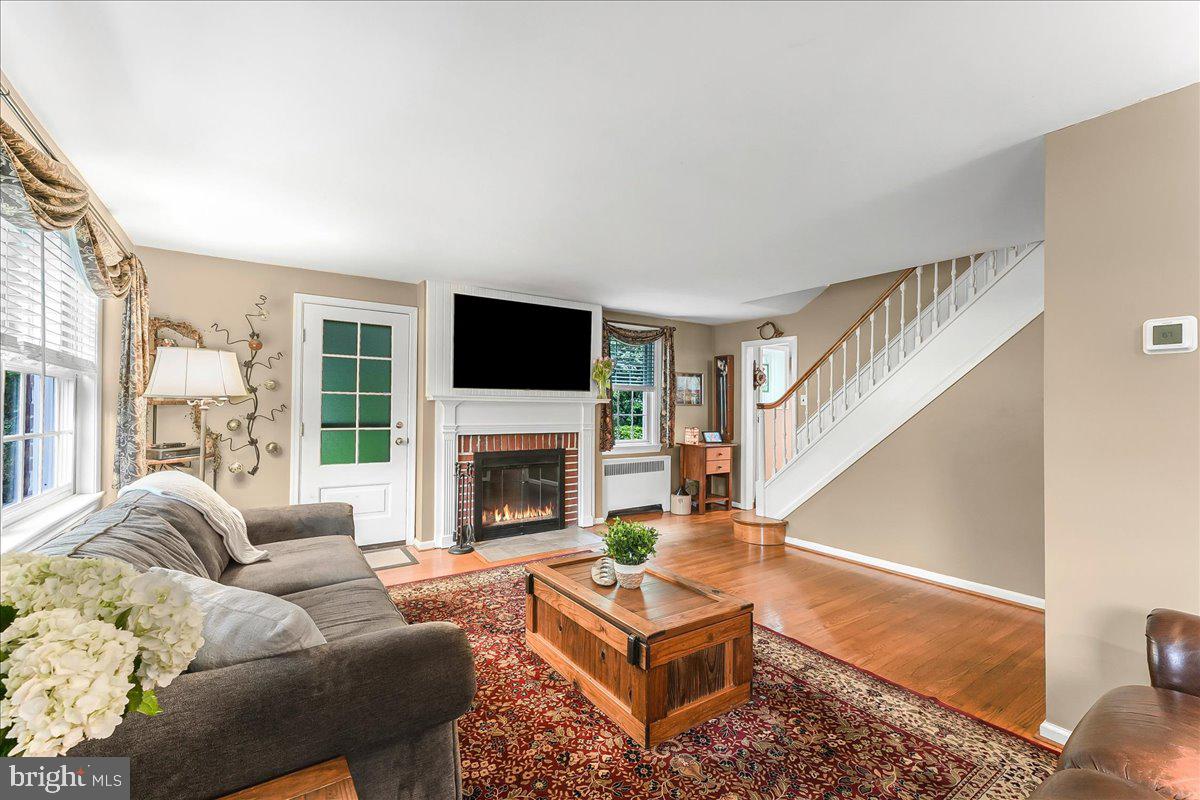 106 Barley Mill Road Wallingford, PA 19086 - Photo 7 of 50 a living room with furniture a flat screen tv and a fireplace