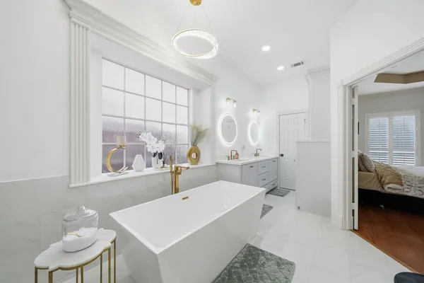 a view of a bathroom with dual sinks