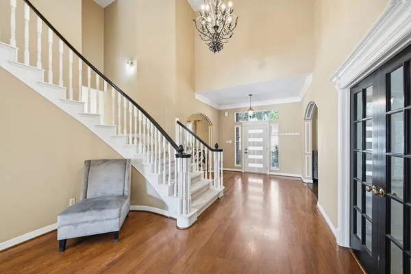 a view of entryway with wooden floor and stairs