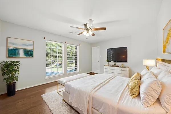 a bedroom with a bed and a flat screen tv