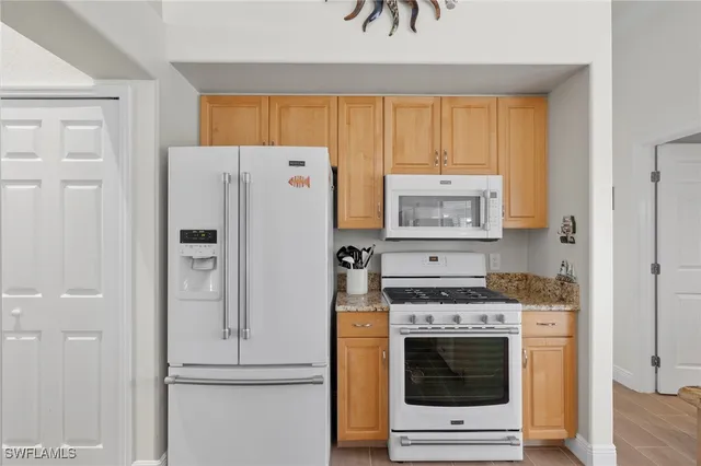 a kitchen with a stove and refrigerator
