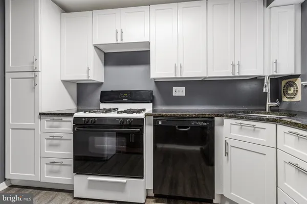 a stove top oven sitting inside of a kitchen