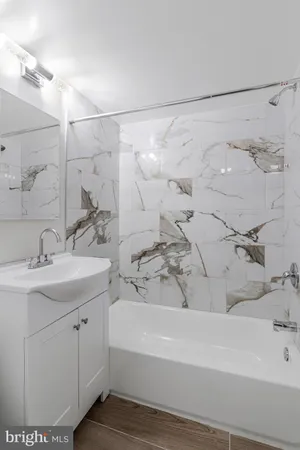 a bathroom with a bathtub and a sink