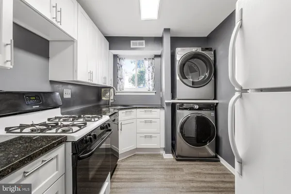 a kitchen with a stove a washer and dryer