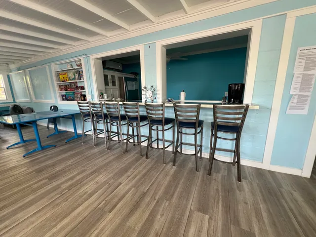 a view of a dinning table and chairs in patio of the house