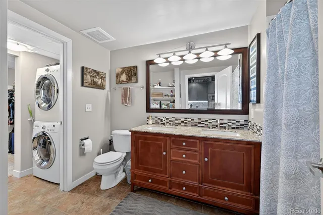 a bathroom with a toilet a sink and a mirror
