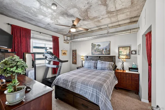 a bedroom with a bed and a potted plant