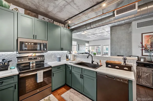a kitchen with stainless steel appliances granite countertop a sink and cabinets