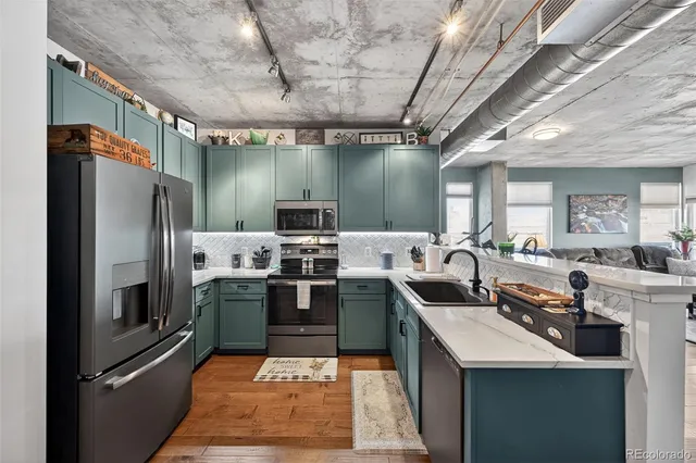 a kitchen with stainless steel appliances granite countertop a sink a counter top space cabinets and stainless steel appliances