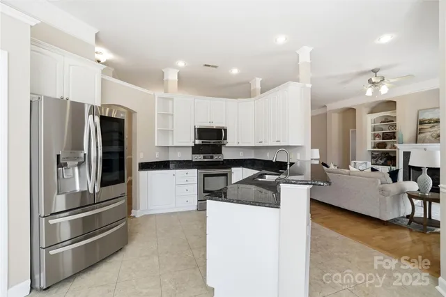 a kitchen with a refrigerator and a stove top oven