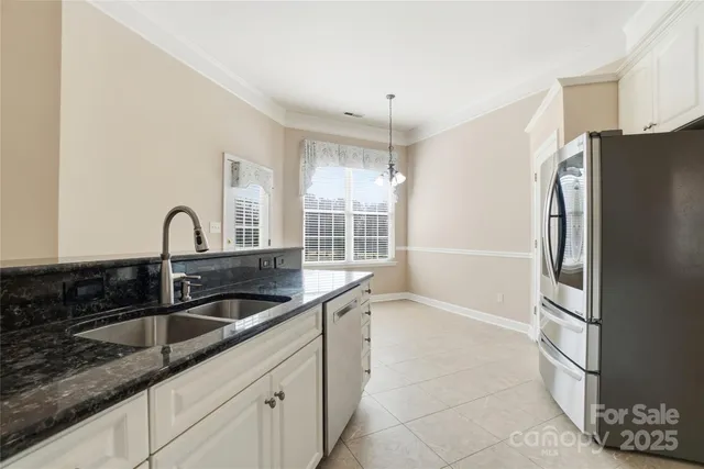 a kitchen with stainless steel appliances granite countertop a refrigerator and a sink