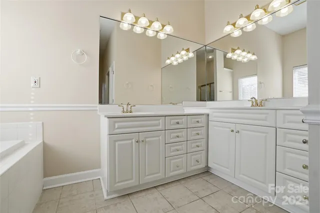 a bathroom with a sink vanity and mirror