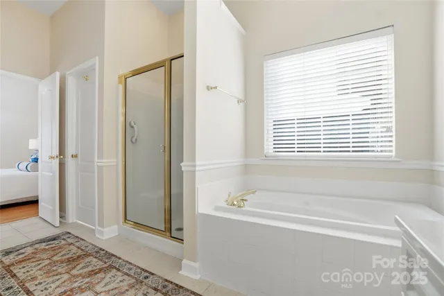 a bathroom with a bathtub and a shower