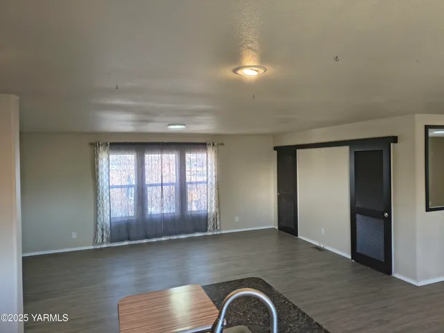 a view of walk in closet with empty racks
