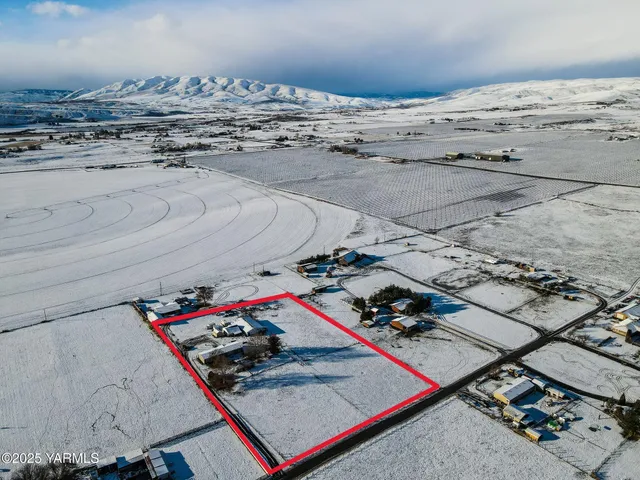 a kitchen with stainless steel appliances granite countertop a sink a stove a refrigerator cabinets and wooden floor