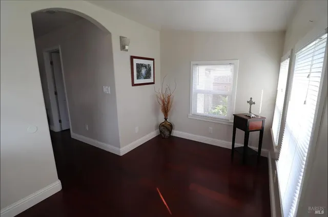 a view of a livingroom with wooden floor and a window