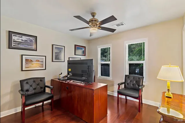 a living room with furniture a fireplace and a window