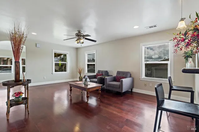 a living room with furniture window and wooden floor