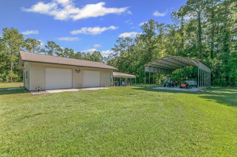 2650 Cabbage Hammock Road St. Augustine, FL 32092 - Photo 60 of 91 a front view of house with yard and trees in the background