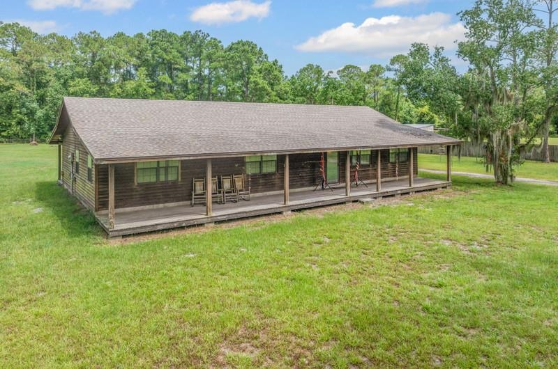 2650 Cabbage Hammock Road St. Augustine, FL 32092 - Photo 73 of 91 Back of property featuring a yard and a shingled roof