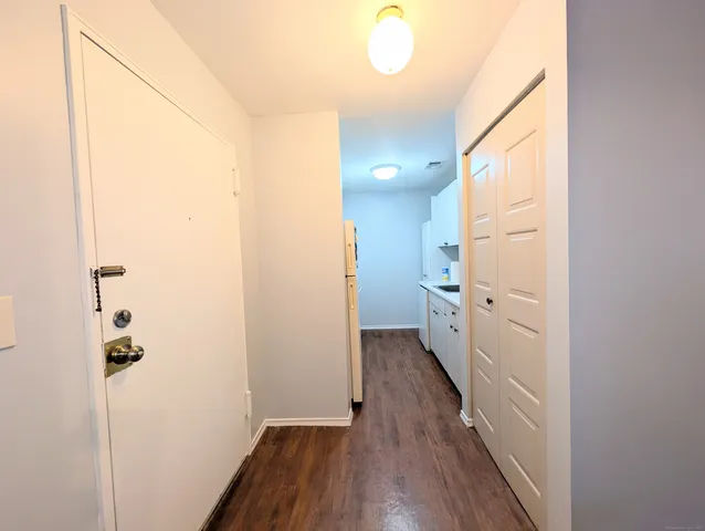 a view of a hallway with wooden floor