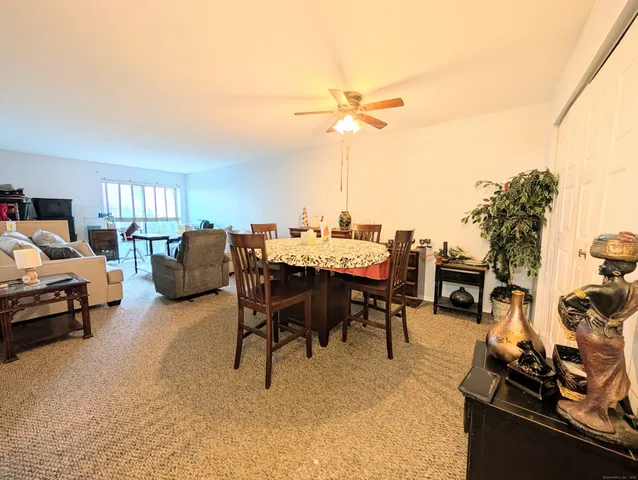 a view of a livingroom with furniture and a dining table