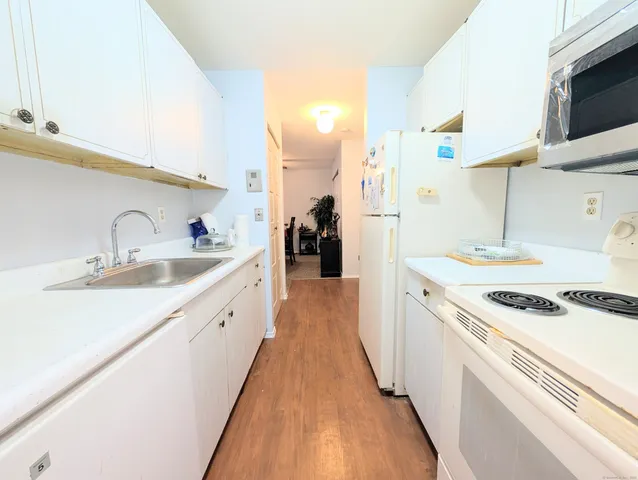 a kitchen with a sink a stove and cabinets