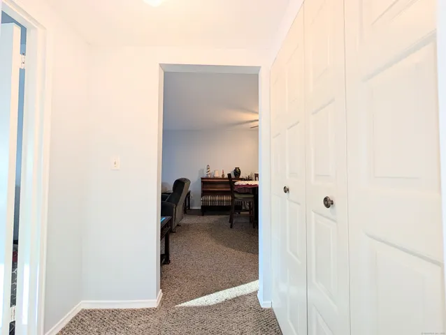 a view of a hallway with living room and a hallway