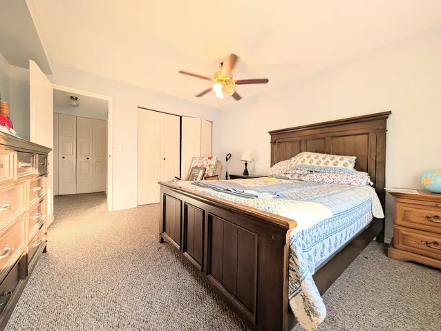 a spacious bedroom with a bed and a chandelier