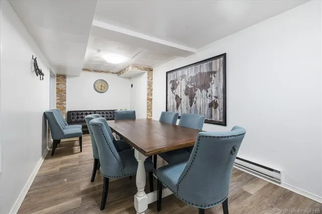 a view of a dining room with furniture and wooden floor