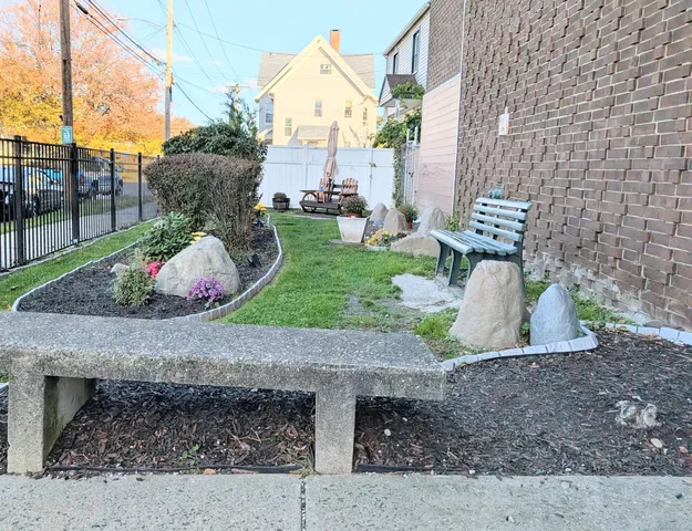 a view of a garden with sitting area
