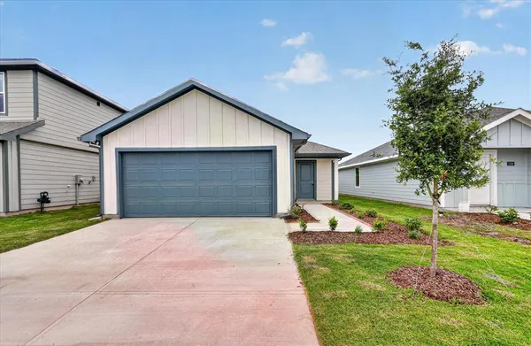 a front view of house with yard and green space