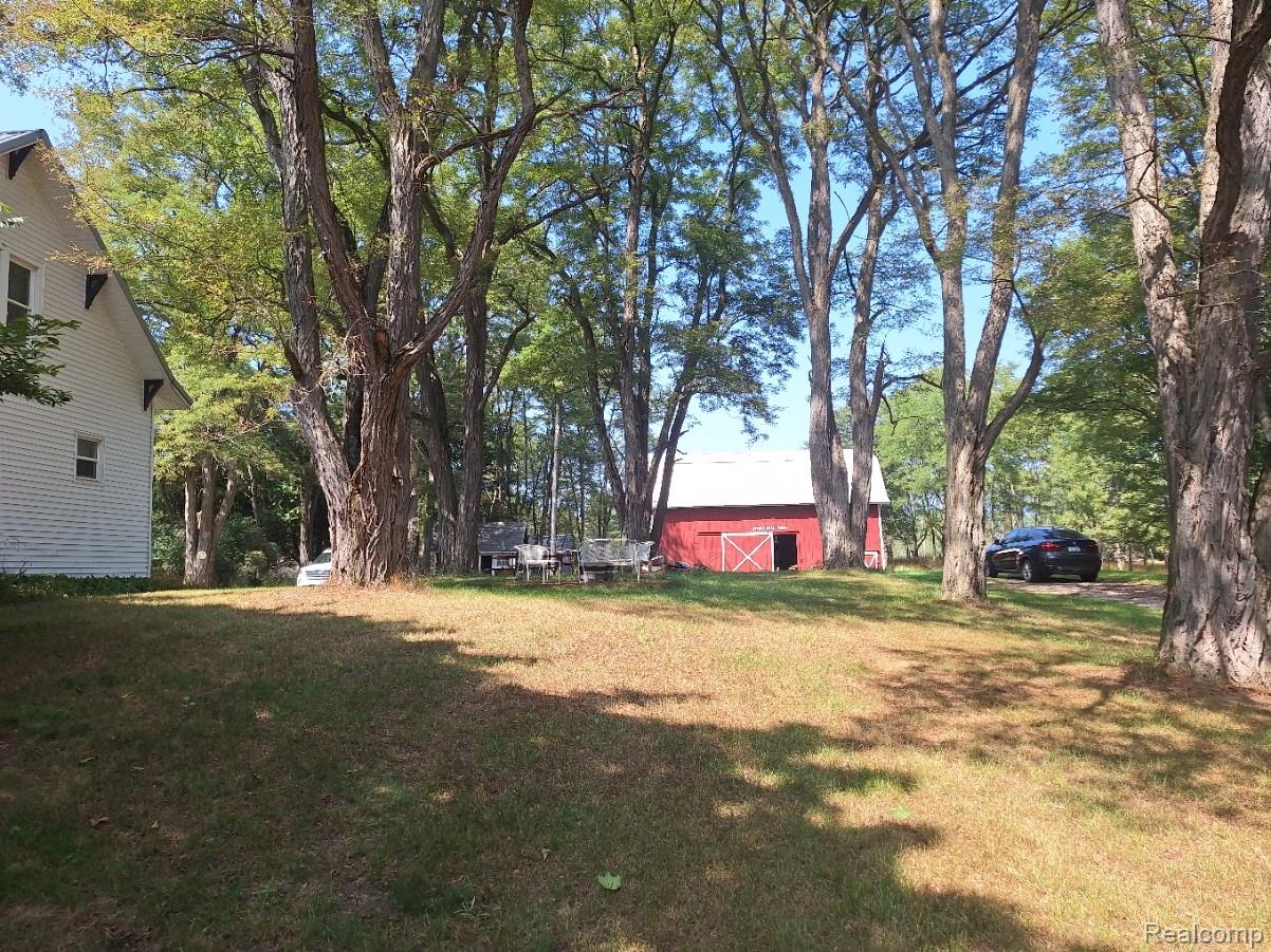 4274 River Road Manistee, MI 49660 - Photo 9 of 26 White exterior with dark trim detailing