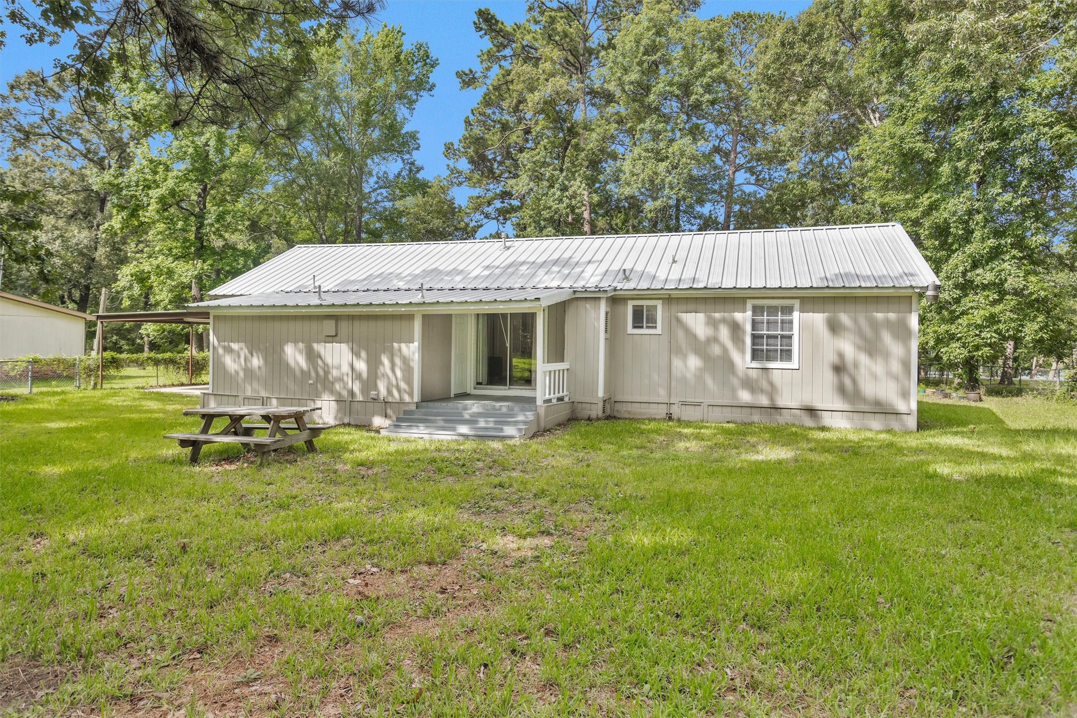 99 Main Street Huntsville, TX 77340 - Photo 42 of 47 Rear of the home surrounded by mature landscaping.