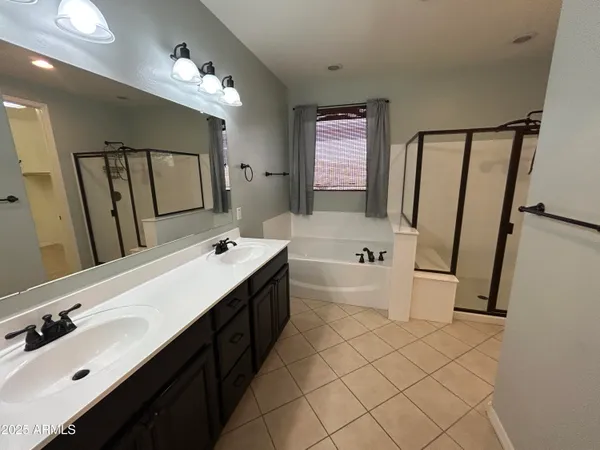 a bathroom with a tub sink and mirror