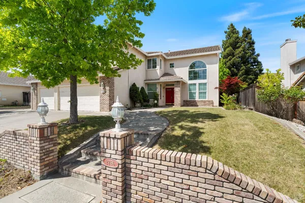 a front view of a house with garden